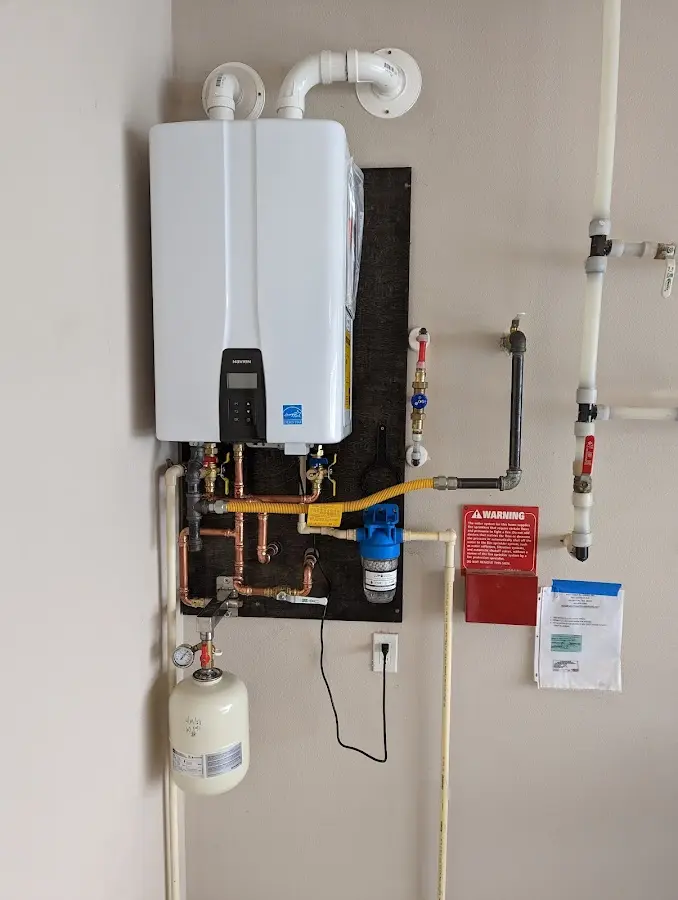 Professional plumber installing copper piping in a Fort Ann home